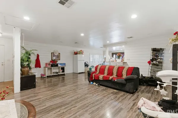 a bedroom with furniture and a wooden floor