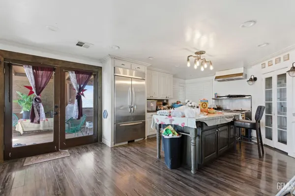 a kitchen with a dining table cabinets and stainless steel appliances