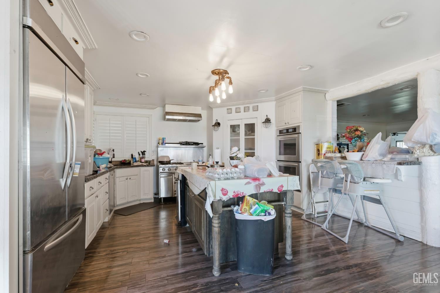 Undisclosed Address Maricopa, CA 93252 - Photo 4 of 40 a kitchen with a dining table cabinets and stainless steel appliances