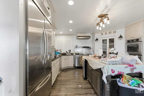 a kitchen with a sink a stove and cabinets