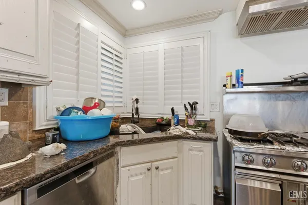 a kitchen with stainless steel appliances granite countertop a stove and a sink