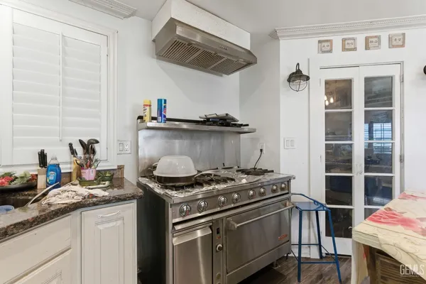 a kitchen that has a lot of cabinets a sink and appliances