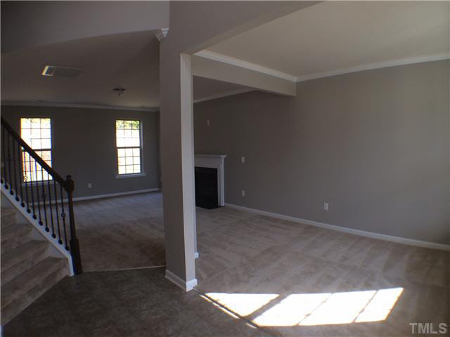 2616 Shepherd Valley Street Raleigh, NC 27610 - Photo 3 of 21 a view of an empty room with wooden floor and a window