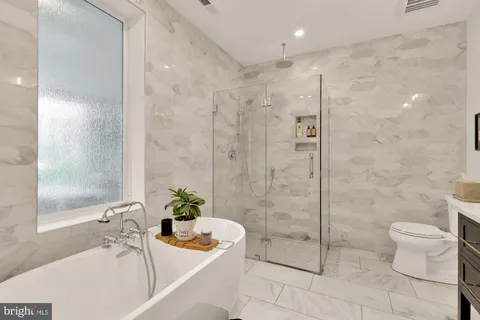 a bathroom with a bathtub and a shower