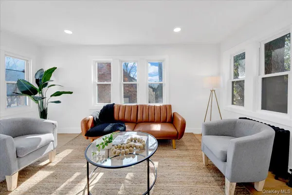 a living room with furniture rug and window