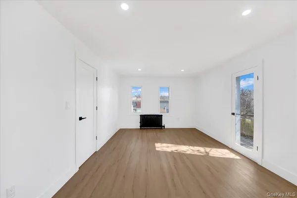 a view of a room with wooden floor and fireplace