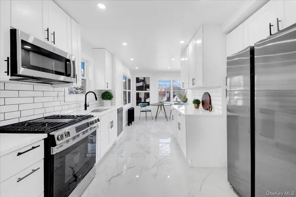 a kitchen with a refrigerator stove and microwave