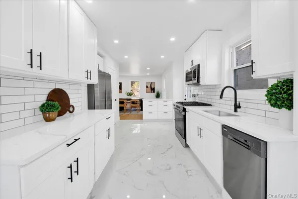 a kitchen with a sink a stove and cabinets