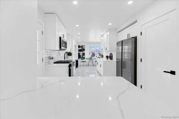 a kitchen with stainless steel appliances a refrigerator sink and stove