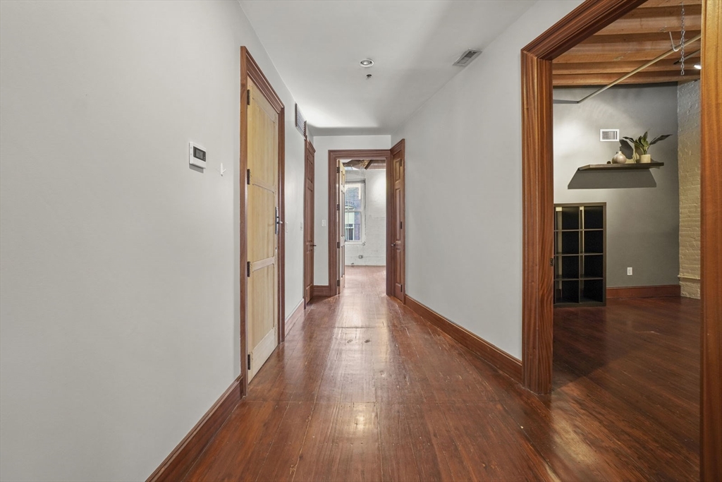 96 South Street, Unit 3 Boston, MA 02111 - Photo 12 of 17 a view of a hallway with wooden floor