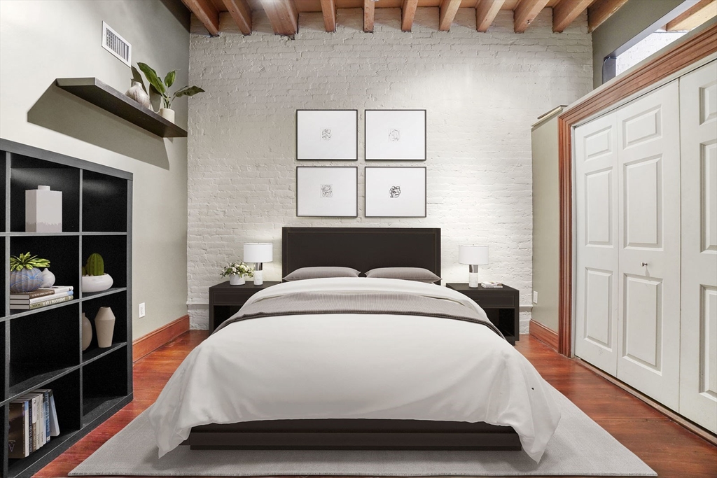 96 South Street, Unit 3 Boston, MA 02111 - Photo 4 of 17 a bedroom with a bed and a window