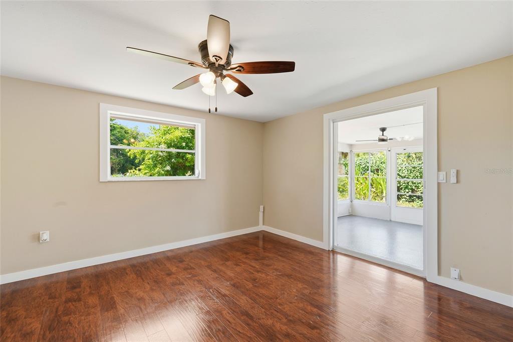 5984 Diana Road Venice, FL 34293 - Photo 20 of 36 a view of an empty room with wooden floor and a window