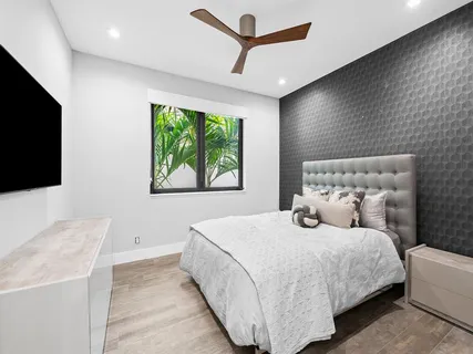 a bedroom with a bed and a flat screen tv