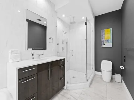 a bathroom with a tub sink and mirror
