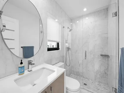 an aerial view of a house with a yard and a large pool