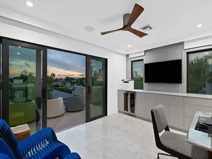 a view of a balcony with couches and wooden floor