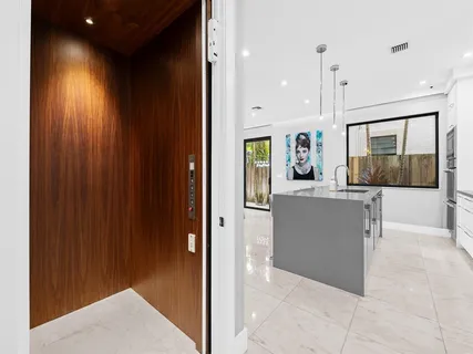 a open kitchen with stainless steel appliances granite countertop a sink a stove and a refrigerator