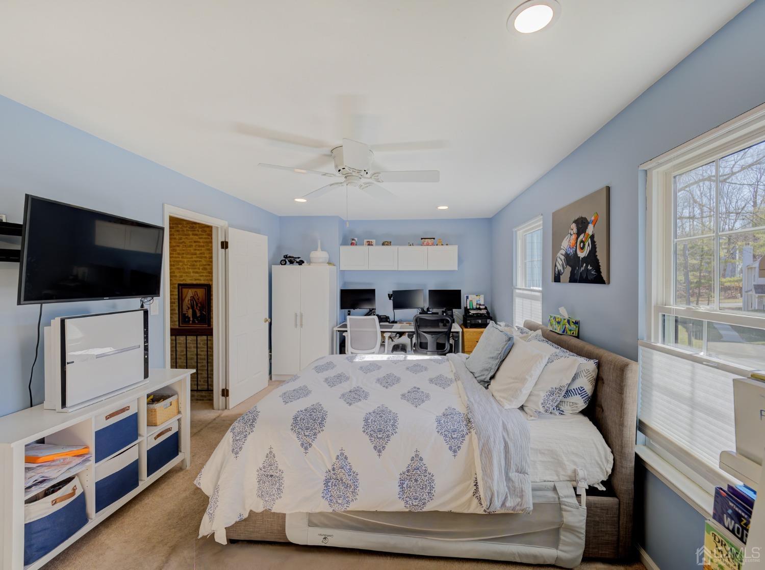 1103 Timber Oaks Road Edison, NJ 08820 - Photo 21 of 27 a large bedroom with a bed and a flat tv screen on the dresser