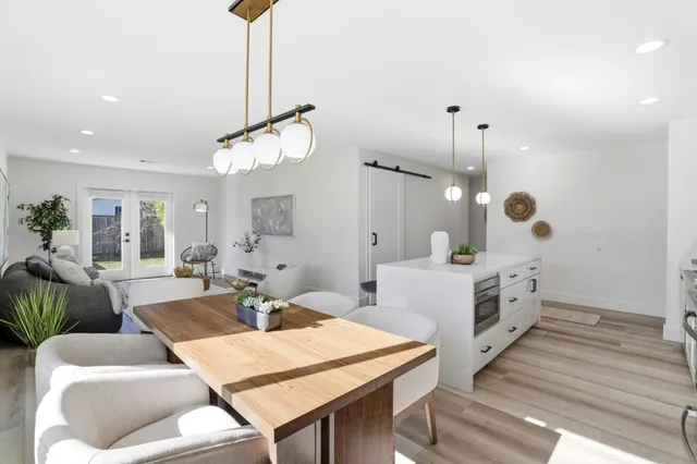 a living room with furniture a rug and white walls