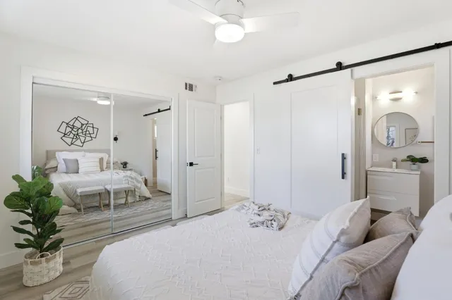 a bedroom with a bed and a mirror