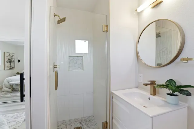 a bathroom with a sink a mirror and a toilet