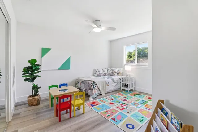 a bed room with furniture and a potted plant