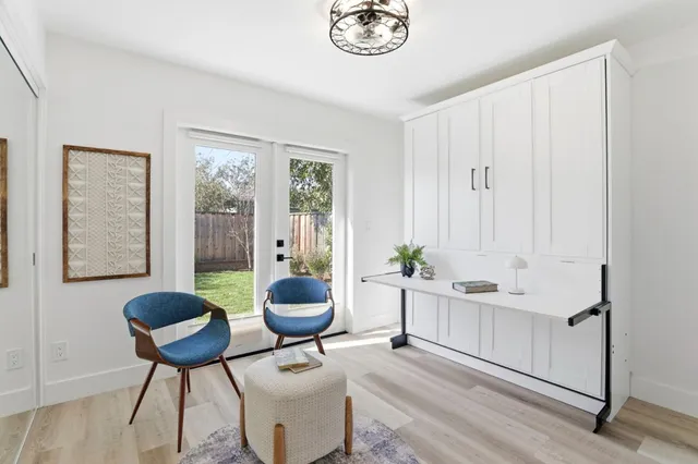 a living room with furniture a window and a potted plant