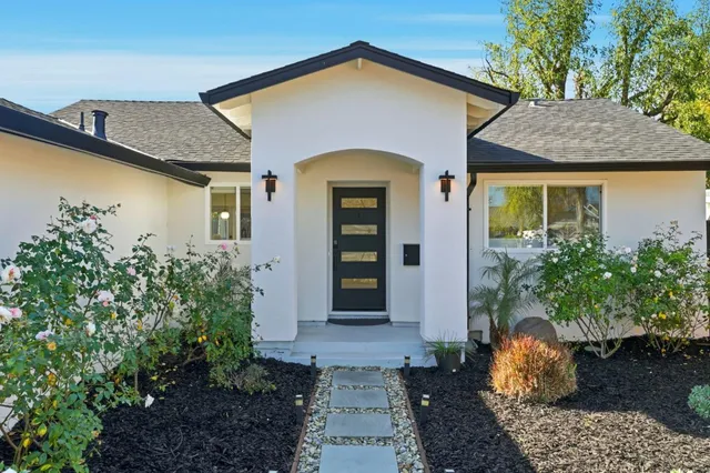 a front view of a house with garden