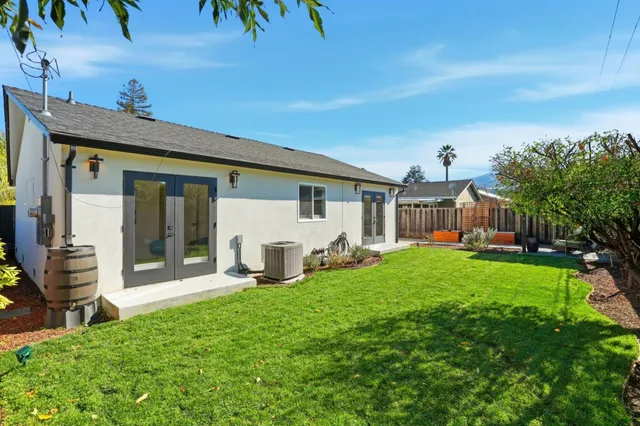 a view of a house with backyard and porch