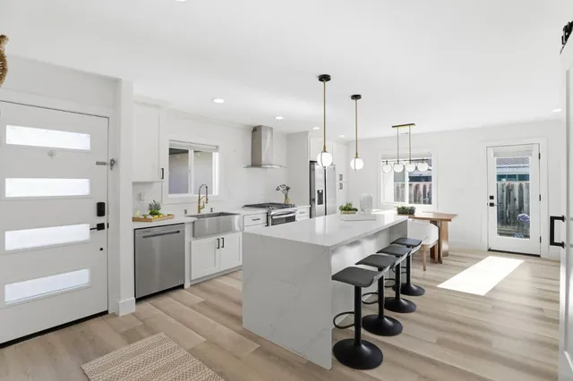 a kitchen with appliances cabinets and wooden floor