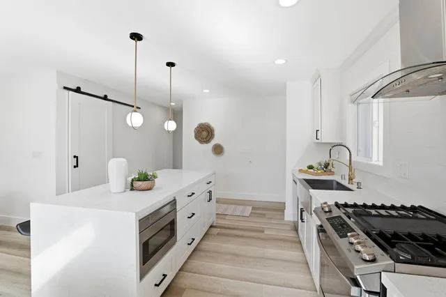 a kitchen with granite countertop a stove and a sink