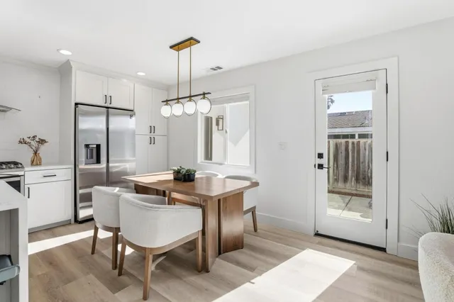 a view of a kitchen area with furniture and wooden floor