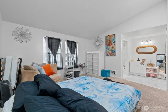 a bedroom with furniture and a large window