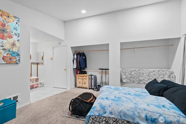 a bedroom with a bed and a table in it