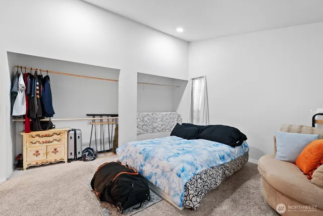 a bedroom with a bed and a couch