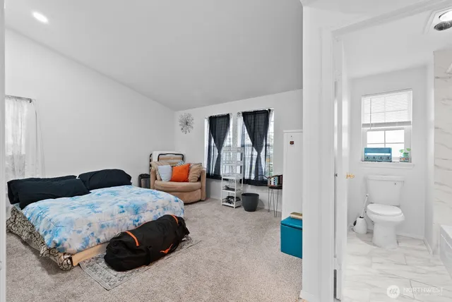 a bedroom with a bed and a couch