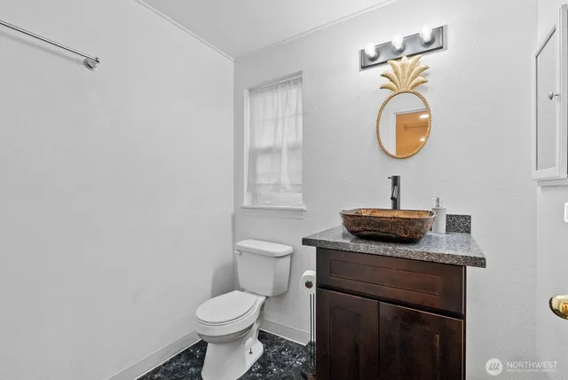 a bathroom with a toilet sink and mirror