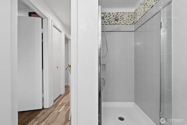 a bathroom with a glass shower door