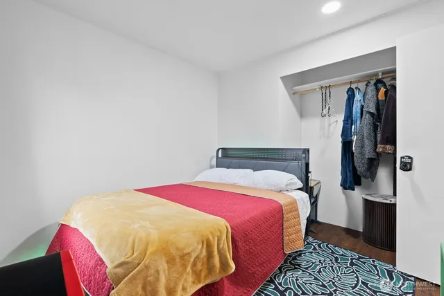 a bed sitting in a bedroom next to a window