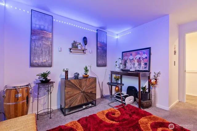 a living room with furniture a rug and a fireplace