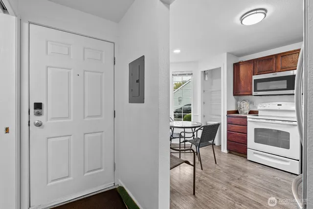a kitchen with a wooden floor and breakfast area