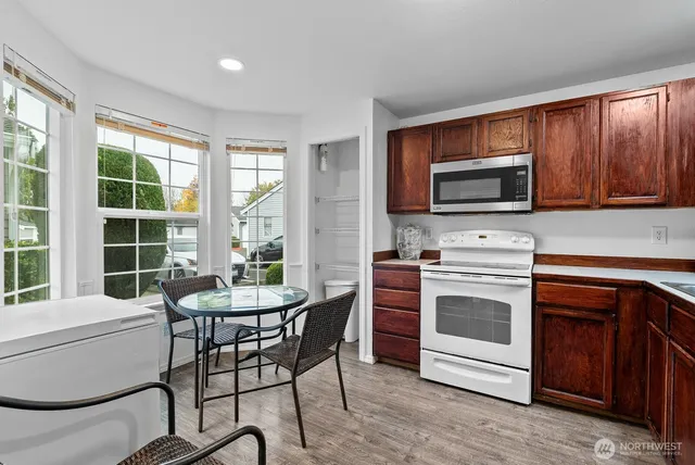 a kitchen with stainless steel appliances a stove a sink and a microwave