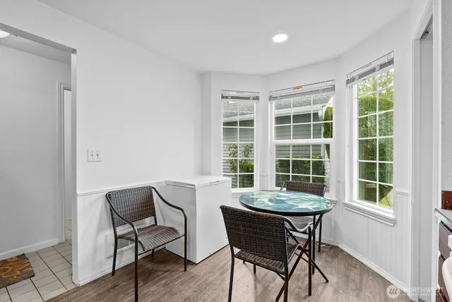 a view of a dining room with furniture and a large window