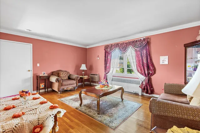 a living room with furniture a rug and a window