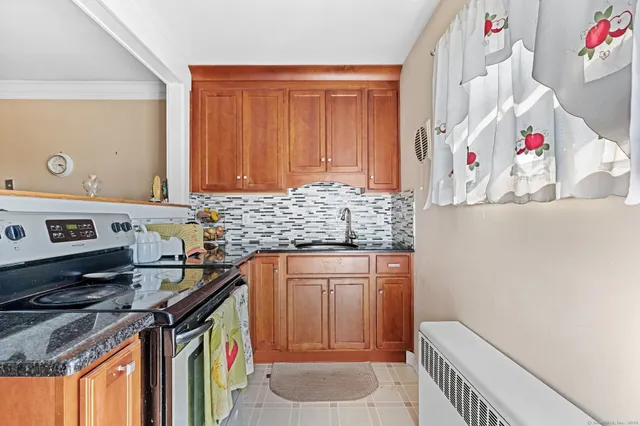 a kitchen with stainless steel appliances granite countertop a stove and a sink