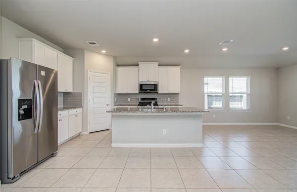 a kitchen with stainless steel appliances granite countertop a sink stove and cabinets