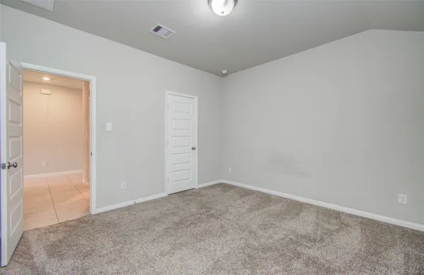 a view of an empty room with a fan