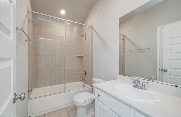 a spacious bathroom with a tub sink shower and a mirror