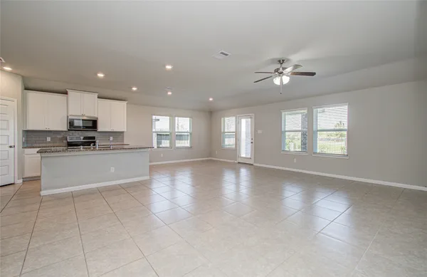 a view of kitchen with furniture and refrigerator