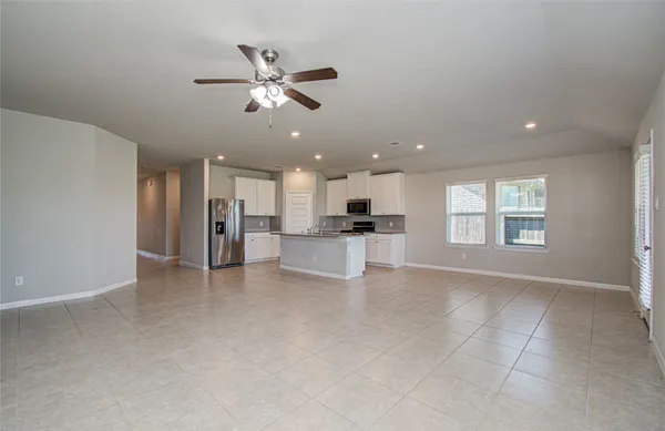 a large kitchen with stainless steel appliances granite countertop a stove a sink and a refrigerator